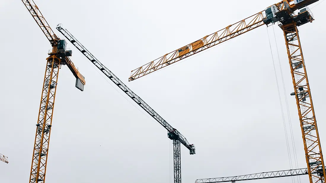 Crane constructing on a blue background, SaaS prototype construction